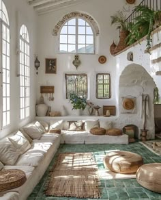 a living room filled with lots of white furniture