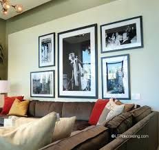 a living room with couches and pictures on the wall