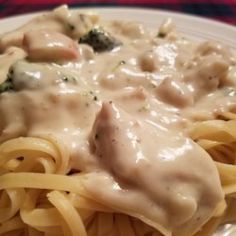 a white plate topped with pasta covered in gravy