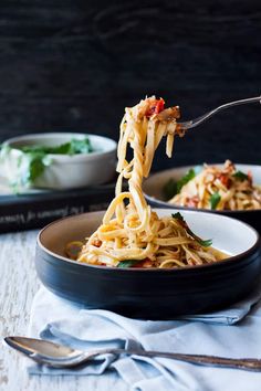 a fork full of spaghetti being lifted from a bowl with the words, valentiney crab linguine