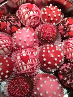 a bowl filled with lots of pink and white chocolate covered in sprinkles