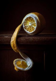 an orange sliced in half sitting on top of a table