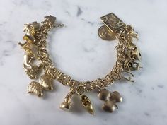 "A WOMENS VINTAGE ESTATE 14k GOLD CHARM BRACELET WITH 17 CHARMS. THE BRACELET WEIGHS 54.8g, AND MEASURES 7 1/2\" LONG. MOST OF THE CHARMS ARE MARKED 14K EXCEPT FOR A FEW OF THEM. THE EIFEL TOWER IS MARKED \"750\". THOSE THAT ARENT MARKED HAVE BEEN TESTED AND ARE GUARANTEED TO BE AS DESCRIBED. ANY QUESTIONS PLEASE DON'T HESITATE TO ASK. THIS MAKES A GREAT GIFT FOR THAT SOMEONE SPECIAL. BE SURE TO CHECK OUT SOME OF MY OTHER GREAT ITEMS UP FOR SALE. THANK YOU." Gold Charm Bracelet Vintage, Vintage Charm Bracelet, Gold Charm Bracelet, Fashion Portfolio, Fine Jewelry Bracelets, Bracelets And Charms, New People, Gold Charm, Charm Bracelets