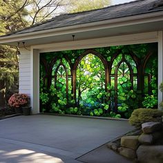 a garage with a mural on the side of it's door and trees in the background