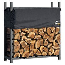 a large pile of logs sitting on top of a metal rack next to a white wall