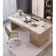 an office desk with a laptop on it