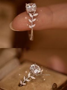 a close up of a person holding a diamond ring