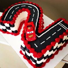 the birthday cake is shaped like a race track