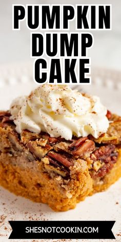 pumpkin dump cake on a white plate with whipped cream and pecans in the middle