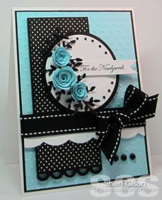 a close up of a card with blue roses on the front and black dots on the back