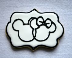 a white and black cookie with two bows on it