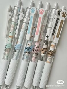 five different sized toothbrushes lined up next to each other on a white surface