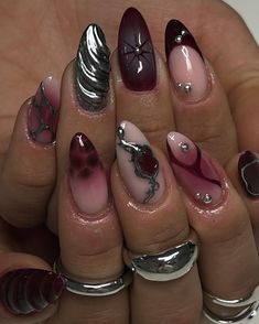 a woman's hand with some manies and rings on her fingers, all in different colors