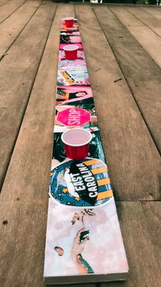 a long row of skateboards sitting on top of a wooden floor next to each other