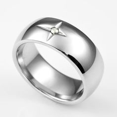 a white gold ring with a star on the center and a diamond in the middle