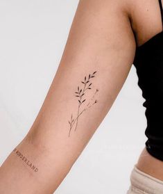 a woman's arm with a small tattoo on the left side of her arm