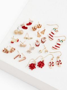 Put the jolly in your holly this holiday season with this set of earrings that are perfect for dressing-up that festive outfit or make for a great gift. Set of 15 . Post and hook backs. Base metals. Imported. The best plus size women's gold-tone red & white holiday earrings set - of 15 sets in multi. Torrid is your destination for cozy fall and winter clothes to keep you warm and comfortable. Torrid is your destination for plus size SALE > CLEARANCE merchandise. Holiday Earrings, Jewelry Picture, Holiday Earring, Christmas Jewelry, Winter Clothes, Cozy Fall, Base Metal, Festival Outfits, Earrings Set