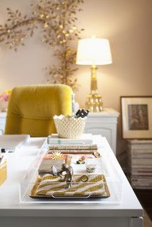 a living room with a yellow chair and white table