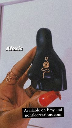 a person holding a black object in their hand with the words alexts on it