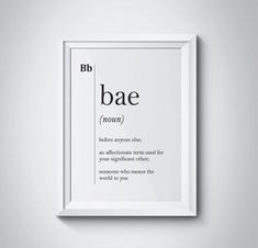 a white frame hanging on the wall with an english word below it that says bae