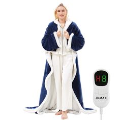 a woman in pajamas standing next to a thermometer on a white background and wearing a blue robe