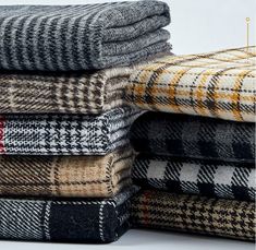 a pile of different colored and black plaid blankets on top of each other with the words,