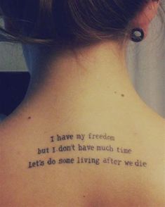 the back of a woman's neck with a tattoo saying i have my freedom but i don't have much time lets do some living after we die