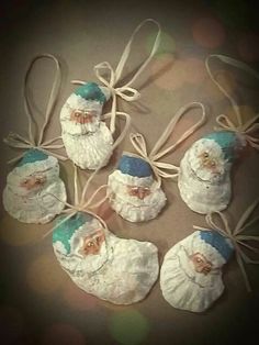 six santa clause ornaments tied together with twine