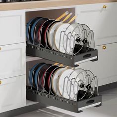 the dish rack is full of dishes and utensils in this modern kitchen setting