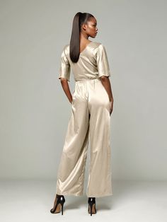 This soft satin jumpsuit features a flattering v-neck design, making it the perfect choice for mothers of the bride. Its dress pantsuit style provides comfort and elegance, while its high-quality material ensures a polished look. Stay stylish and comfortable on that special day with our jumpsuit. Silk V-neck Party Sets, Chic Satin V-neck Jumpsuits And Rompers, Elegant V-neck Evening Set, Elegant V-neck Workwear Sets, Chic Satin Sets For Evening, Elegant V-neck Sets For Night Out, Elegant Satin V-neck Sets, Formal Satin V-neck Jumpsuit, Elegant V-neck Party Sets