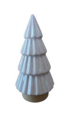 a white ceramic christmas tree sitting on top of a table