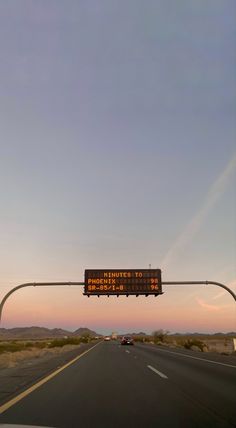 an electronic sign on the side of a road that warns drivers to stop and go