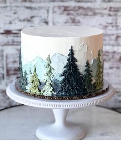 a white cake with trees painted on it