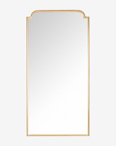 a gold framed mirror on a white wall