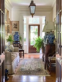 the hallway is decorated with blue and white vases on either side of the door