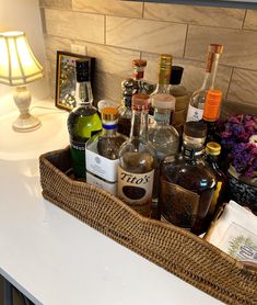 a basket filled with liquor bottles sitting on top of a counter