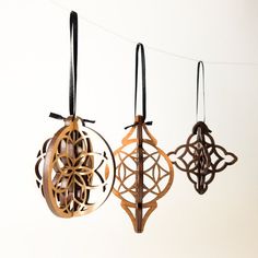 three wooden ornaments hanging from a string