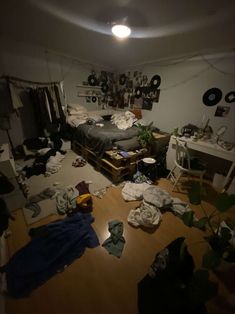 a messy bedroom with clothes scattered all over the floor