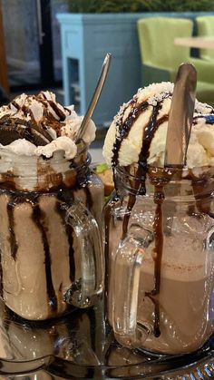 two desserts with ice cream and chocolate sauce are on a glass plate next to each other