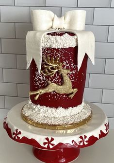 a red and white cake with gold decoration