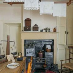 an old fashioned kitchen is shown in this image, with many items on the table