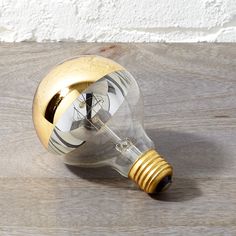 an old fashioned light bulb on a wooden table