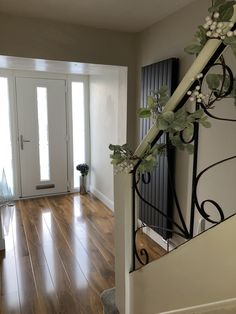 an entry way with wooden floors and white doors