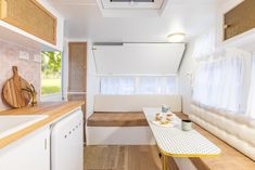 a kitchen area with a table, sink and window