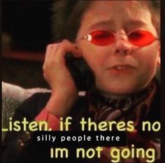 a child wearing red glasses talking on a cell phone with the caption listen, if theres no movement, i'm not going