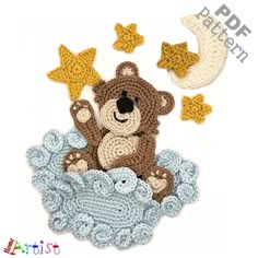 a crocheted teddy bear sitting on top of a cloud with stars and moon