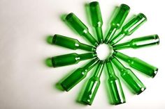 green glass beads arranged in a circle on a white surface