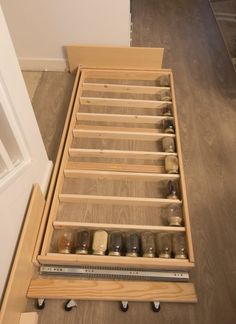 an open drawer with many jars on it