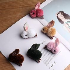 several small stuffed animals sitting on top of an open book