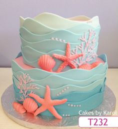 a blue and pink cake with starfish on it